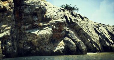 CGI Rocky cliff landscape with clear water under bright sunny sky near coast video