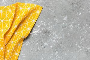 top view with yellow empty kitchen napkin isolated on table background photo
