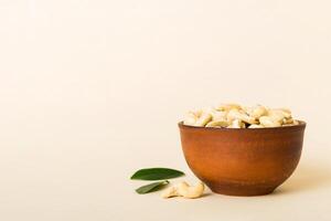 cashew nuts in wooden bowl on table background. top view. Healthy food photo