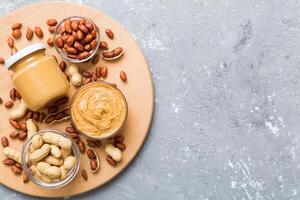 Bowl peanut butter and peanuts on table background. top view . Creamy peanut pasta photo