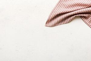 top view with red empty kitchen napkin isolated on table. Folded cloth for mockup photo