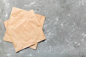 top view with baking parchment empty on table background. Folded cloth for mockup with copy space, photo