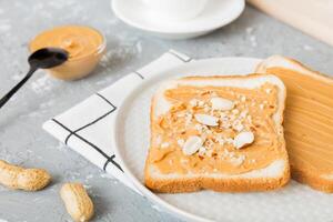 Peanut butter sandwiches toasts on light table background.Breakfast. Vegetarian food. top view photo