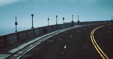 CGI Curved road along coastline enveloped in fog on a quiet morning video