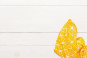 top view with yellow empty kitchen napkin isolated on table background. Folded cloth photo