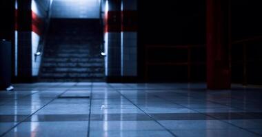 CGI Dark underground passageway with shiny tiles and illuminated stairs ahead video
