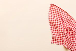 top view with red empty kitchen napkin isolated on table background. Folded cloth for mockup , photo