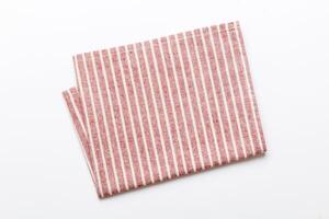 top view with red empty kitchen napkin isolated on table background. Folded cloth mockup with copy space photo