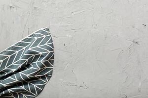 top view with blue kitchen napkin isolated on table background. Folded cloth for mockup with copy space. photo