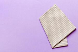 top view with gray kitchen napkin isolated on table background. Folded cloth mockup with copy space, photo