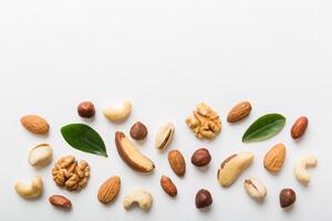 Composition of nuts ,flat lay mix hazelnuts, cashews, almonds on table background. healthy eating concepts and food background photo