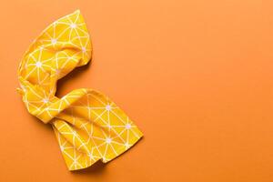 top view yellow empty kitchen napkin isolated on table background. Folded cloth for mockup with copy space photo