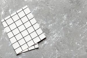 top view with white empty kitchen napkin isolated on table background. Folded cloth photo