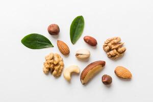 Composition of nuts, flat lay mix hazelnuts, cashews, almonds on table background. healthy eating concepts and food background photo