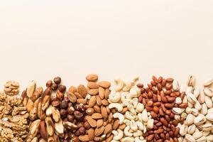 different nuts frame background. flat lay with vopy space. Walnut, pistachios, hazelnuts photo