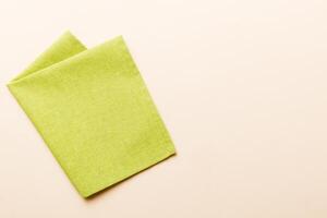top view with green kitchen napkin isolated on table background. photo