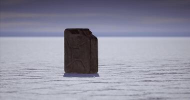CGI Lonely jerry can on salt flat under cloudy sky during twilight hours video