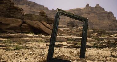 CGI Empty picture frame in bright sunlight by rugged desert landscape video