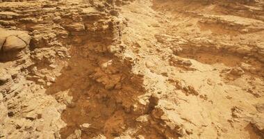 CGI Exploring rugged terrain with golden rock formations during bright daylight video