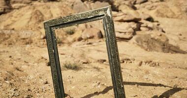 CGI Artistic frame standing alone in a desert landscape under bright sunlight video