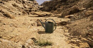 CGI Dry landscape featuring an empty watering can on cracked ground in a desert video