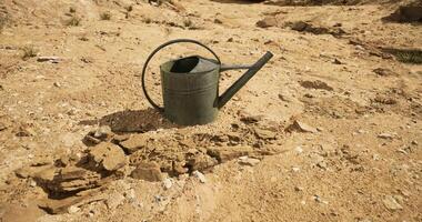 CGI Dry landscape with an empty watering can abandoned in cracked soil video
