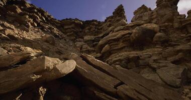 CGI Rock formations rise dramatically under a clear sky in a natural landscape video