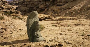 CGI Ancient stone carving in rocky desert landscape under clear sky video