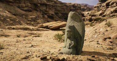 CGI Ancient stone carving of a deity found in arid landscape video