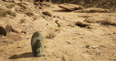 CGI Ancient stone carving standing alone in a dry desert landscape video