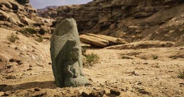 CGI Ancient stone carving stands alone in arid landscape video