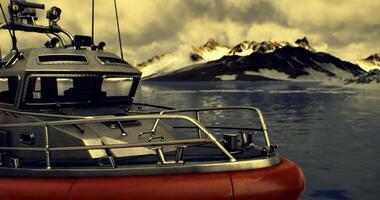 CGI Rescue boat positioned on calm waters near snow capped mountains video