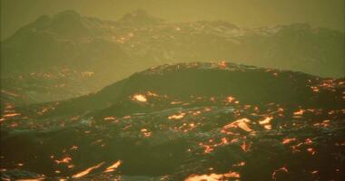 CGI Lava flows illuminate volcanic landscape at dusk in a dramatic display video