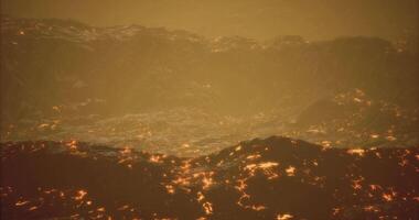 CGI Lava flows create glowing landscape at an active volcano during twilight video