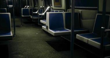 CGI Empty subway train interior with blue seats and dim lighting during late night video