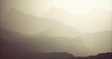 CGI Misty mountain landscape at dawn with layered hills in soft sunlight video
