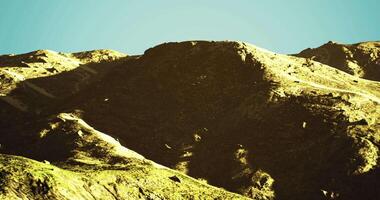 CGI Mountains basking in sunlight under a clear sky during midday hours video