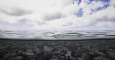 CGI View of tranquil water surface with clouds reflecting above and stones below video