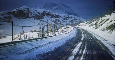 CGI Winter road winding through snow covered mountains at dusk video