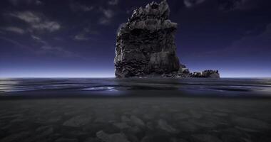CGI Rock formation rising from calm ocean waters at dusk during twilight hours video