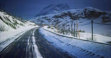 CGI Snow covered road winding through mountain landscape during twilight video