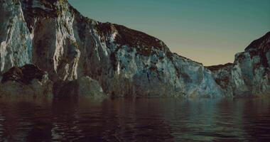CGI Waves lapping against the rugged cliffs at twilight near the tranquil water video