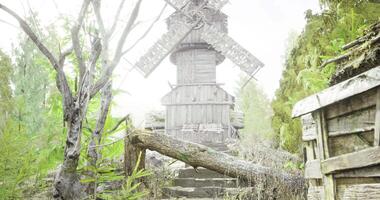 CGI Wooden windmill surrounded by greenery on a foggy day in a rural setting video