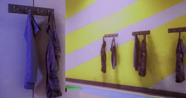 CGI Colorful wall with hanging garments in a small creative space for activities video