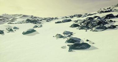 CGI Snowy mountain landscape with rocks under a soft afternoon sky video