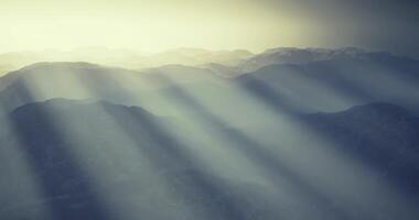 CGI Mountain landscape with sunlight rays piercing through misty atmosphere video