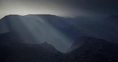 CGI Mountain landscape with dramatic light shining through clouds during dusk video