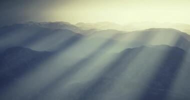 CGI Majestic mountain range bathed in soft rays of sunlight at dawn video