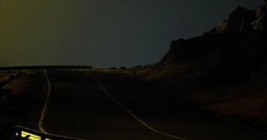 CGI Mysterious night scene on a deserted road surrounded by rocky landscape video
