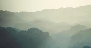 CGI Misty mountain landscape with layered peaks at dawn offering serene views video